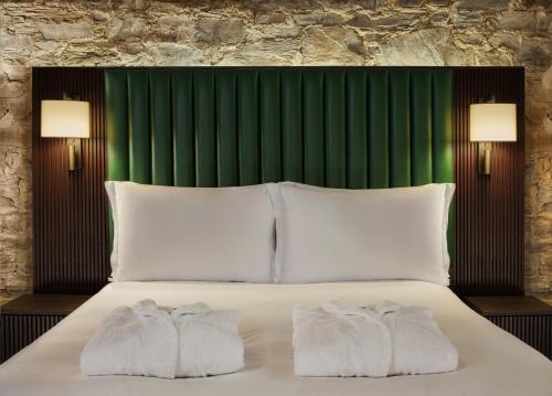 a bedroom with a bed with two towels on it at Bodmin Jail Hotel in Bodmin
