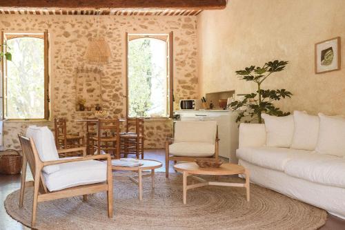 a living room with a couch and a table at Le Galinier, a Beaumier hotel in Lourmarin