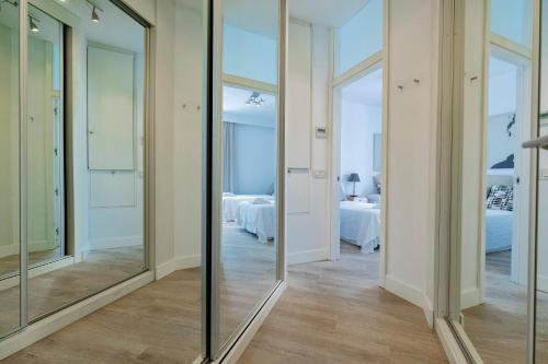 a hallway with mirrors and a room with beds at Villa Flamingos Marbella in Marbella