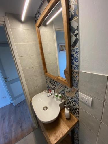 a bathroom with a sink and a mirror at La Magnolia in Greve in Chianti