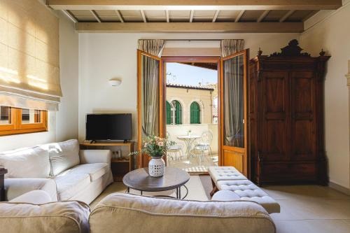 a living room with a couch and a table at Z Boutique Hotel in Panormos Rethymno