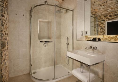 a bathroom with a shower and a sink at Bodmin Jail Hotel in Bodmin