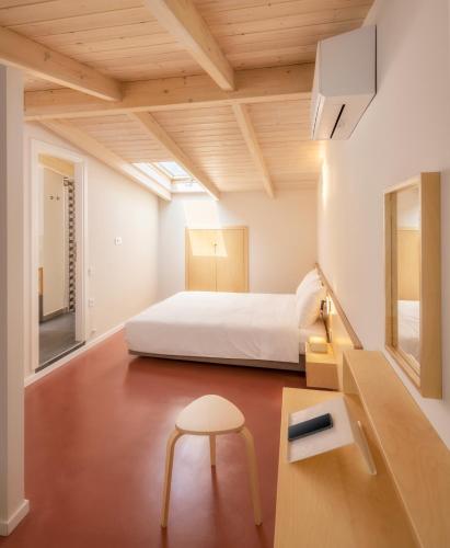 a bedroom with a bed and a table and a stool at ASTRA IN CITY in Ioannina