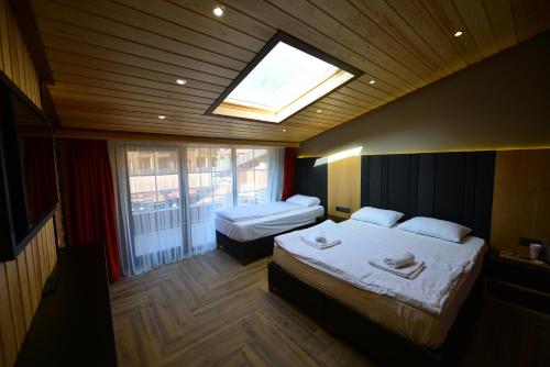 Ένα ή περισσότερα κρεβάτια σε δωμάτιο στο Inanlar Deluxe Hotel & Bungalow