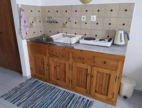a kitchen with a sink and a counter top at Stamoulis Apartments in Kámpos
