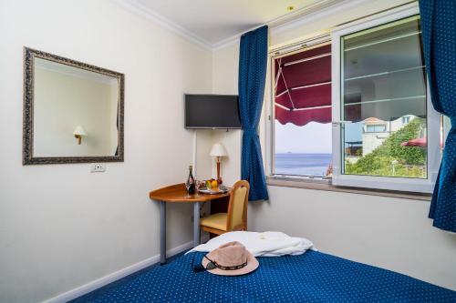 a hotel room with a bed and a window at Boutique & Beach Hotel Villa Wolff in Dubrovnik