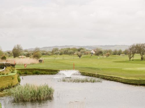 a view of a golf course with a pond at Number 8 Lakes View in Burnham on Sea