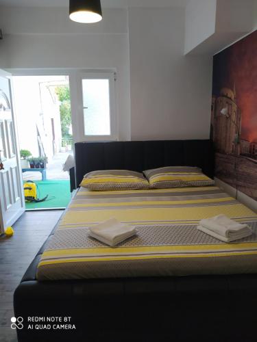 a bedroom with a bed with two towels on it at Cvita & Maja in Zadar