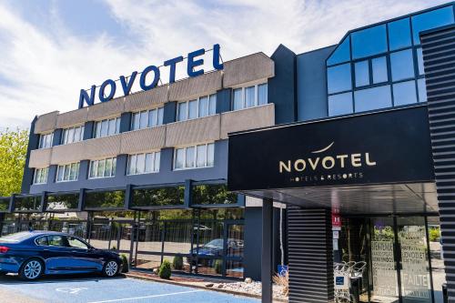 a november hotel with a car parked in front of it at Novotel Orléans Saint Jean de Braye in Saint-Jean-de-Braye