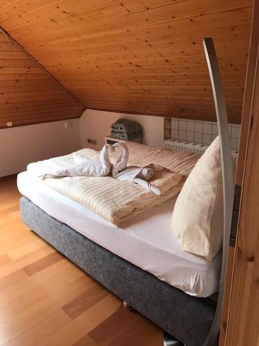 a bed in a room with a wooden ceiling at Penthouse Mosel Huntress in Gornhausen
