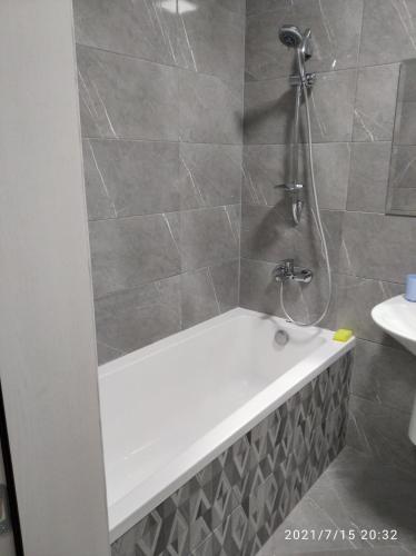 a bathroom with a bath tub and a shower at ЖК Версаль парк in Irpin'