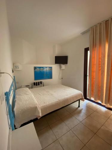 a bedroom with a bed and a television in it at Palau City Hotel in Palau