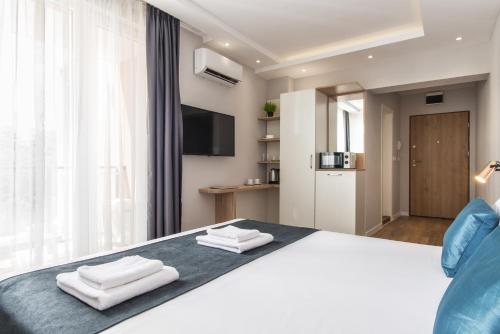 a bedroom with a bed with towels on it at Casa Paradiso Apartments in Ahtopol
