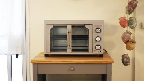 a microwave oven sitting on top of a table at בין האלונים in H̱arashim