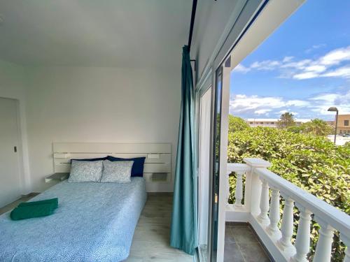 a bedroom with a bed on a balcony at Apartamento MEDAL in El Cotillo