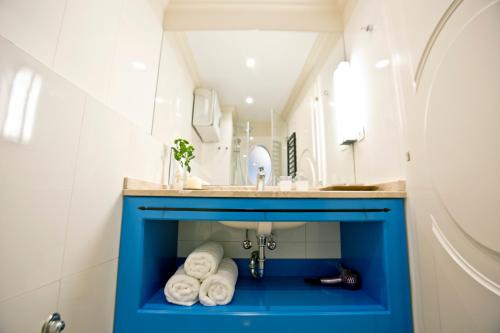 a bathroom with a blue sink with towels under it at Borelli Palace & Borelli Blue in Zadar