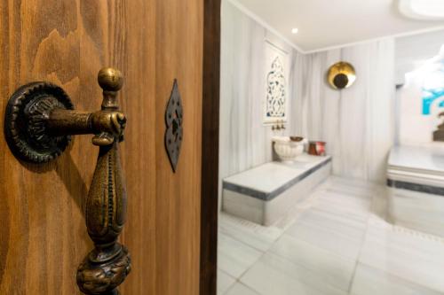a wooden door with a handle and a room at Romance Istanbul Hotel Boutique Class in Istanbul