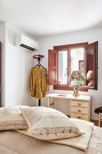 a bedroom with a bed and a desk and a window at Balcon de Europa in Nerja