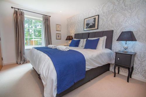 a bedroom with a large bed and a window at The Steading Apartment in Aviemore