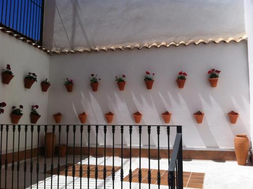 a wall that has a bunch of clocks on it at Don Paula in Córdoba