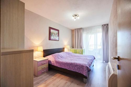 a small bedroom with a bed and a window at Villa Grdelina in Supetar