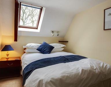 a bedroom with a bed and a window at The Old School House Hotel in Sutton Coldfield