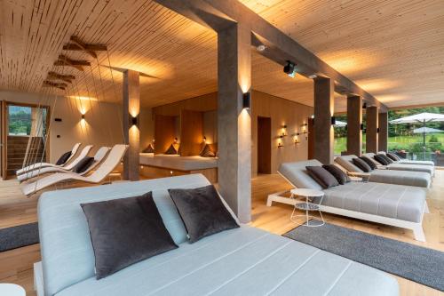 a room with several couches and chairs in it at Sackmann Genuss und Spa Resort in Baiersbronn