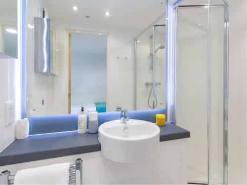 a white bathroom with a sink and a shower at For Students Only Market House in Newcastle in Newcastle upon Tyne