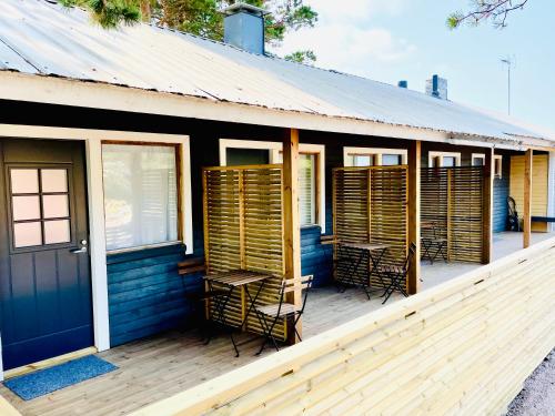 a deck with chairs and tables on a house at Kaunissaaren Maja in Kotka