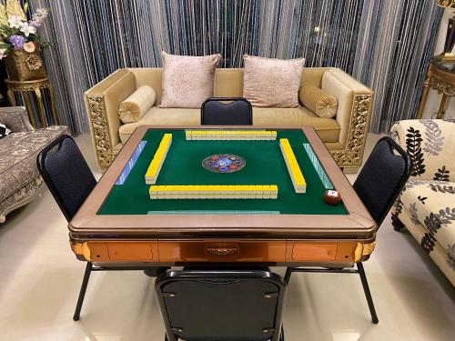 a poker table in a room with a couch at 北歐小宅-市區電梯民宿附停車位 in Hualien City
