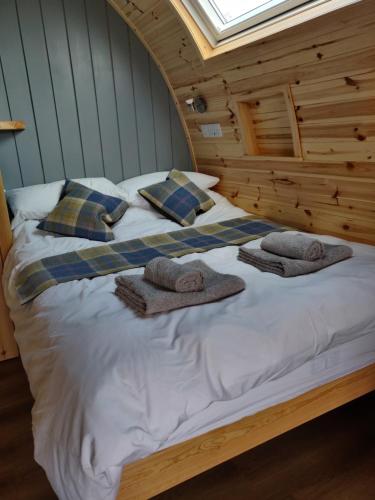 a bedroom with a bed with towels on it at Braeview Escapes in Eyemouth