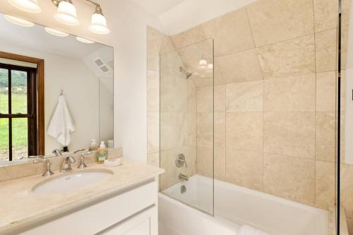 a bathroom with a sink and a shower at Chaparral Aspen Ranch Cabin in Woody Creek