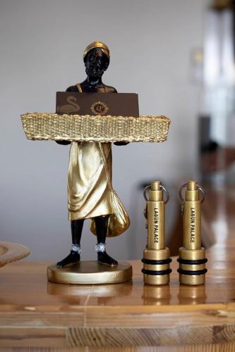 a statue of a man holding a cross on a table at Lagun Palas in Yalova