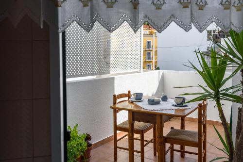a small table and chairs on a balcony at Cister House in Alcobaça