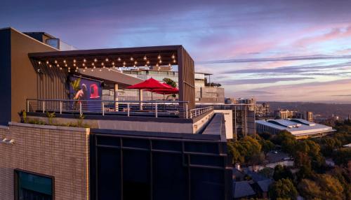a building with a red umbrella on top of it at Radisson RED Hotel Johannesburg Rosebank in Johannesburg