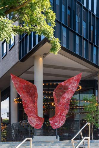 a sculpture of two wings in front of a building at Radisson RED Hotel Johannesburg Rosebank in Johannesburg