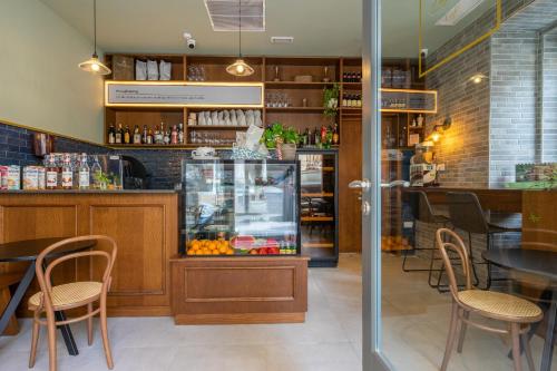 a restaurant with a counter and tables and chairs at Lady Todd in Sliema