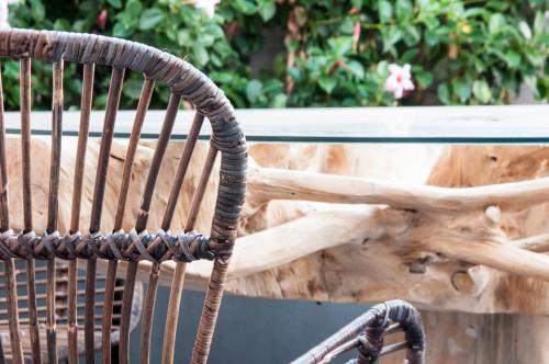 a wooden chair sitting in front of a bench at ca' squero911 luxury rooms in Cesenatico