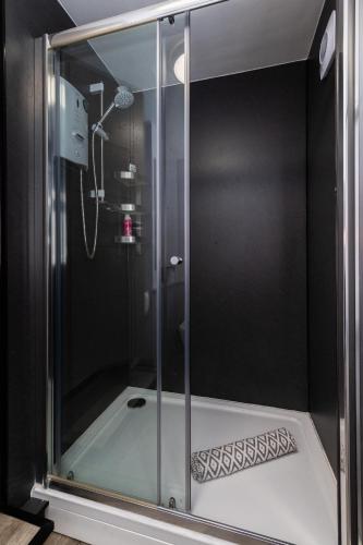 a shower with a glass enclosure in a bathroom at Thornbeck Manor Lake Windermere in Windermere