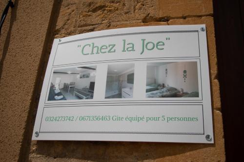 a sign for a shop on the side of a building at "Chez la Joe" in Thélonne