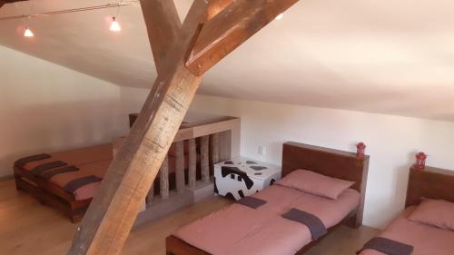 an attic room with two beds and a staircase at Village house Moo Moo in Vranje