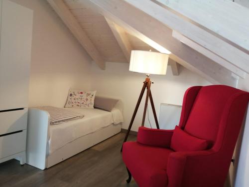 a bedroom with a red chair and a bed at Bellagio Holiday Home in Bellagio