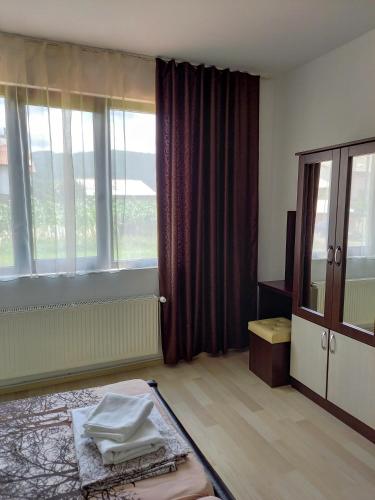a room with a bed and a large window at Къща за гости "Тони" in Dobrinishte