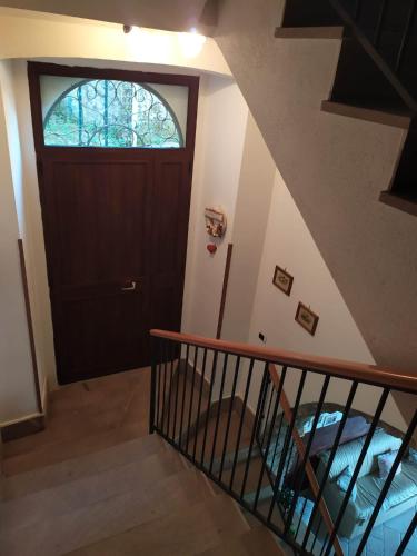 a staircase with a wooden door and a window at B&B La Carosella in Vatolla