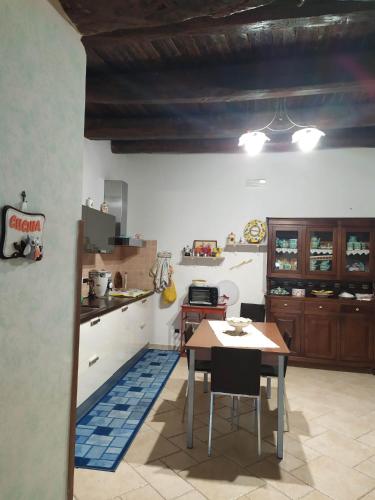 a kitchen with a table in the middle of it at B&B La Carosella in Vatolla