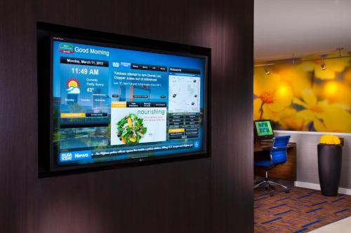 a television hanging on a wall in a room at Courtyard by Marriott Little Rock West in Little Rock