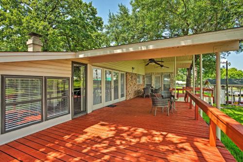 a large wooden deck with chairs on it at Cedar Creek Reservoir Home with Deck and Dock in Gun Barrel City