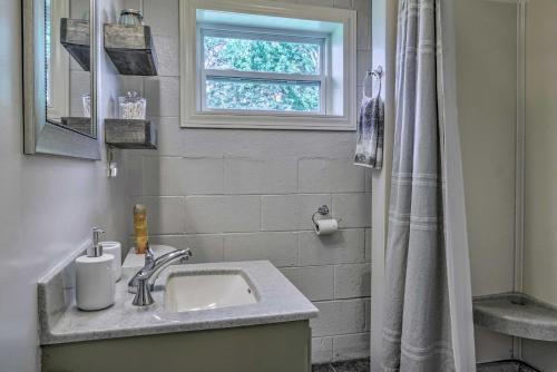 a bathroom with a sink and a window at Quiet Country Home in Ava with Chic Interior! in Ava