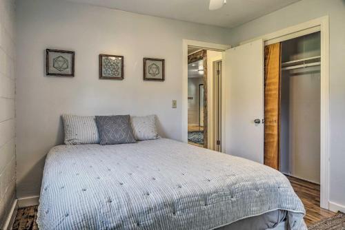 a bedroom with a bed with two pictures on the wall at Quiet Country Home in Ava with Chic Interior! in Ava