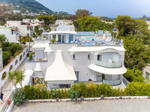 a white house with a view of a city at Ischia Mavilan Luxury Apartments in Ischia